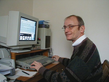 [Photo: Derryck at desk]