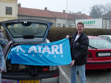 [Photo: TXG holding an Atari flag]