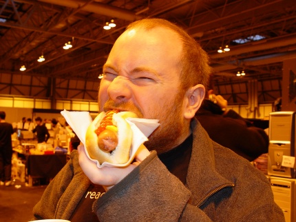 [Photo: Hungry man eat hotdog]