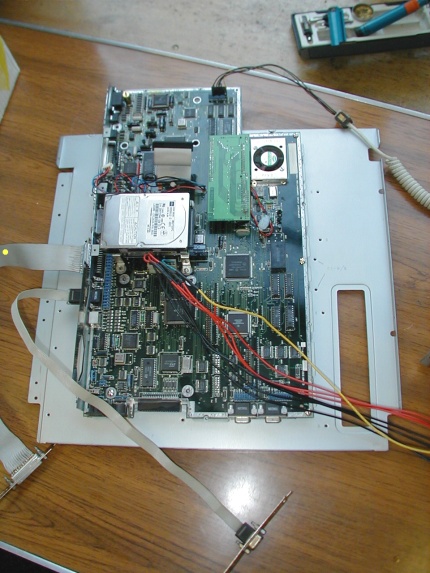 [Photo: Motherboard mounted on tray]