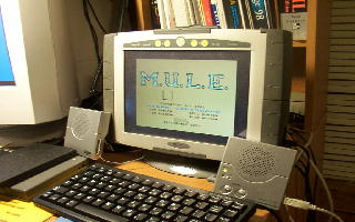 [Photo: Genesys on desktop with speakers and keyboad]