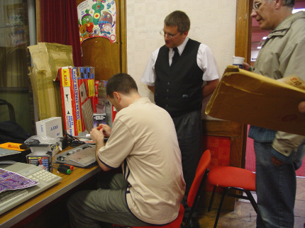 [Photo: Rob, Steve and Mark look as Rob upgrades his 130XE]
