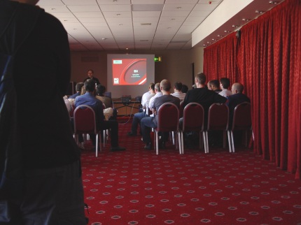 [Photo: Andrew Oliver lecturing]